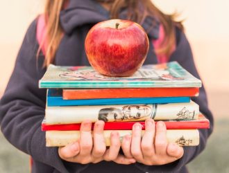 crop-girl-with-books-apple_23-2147863702