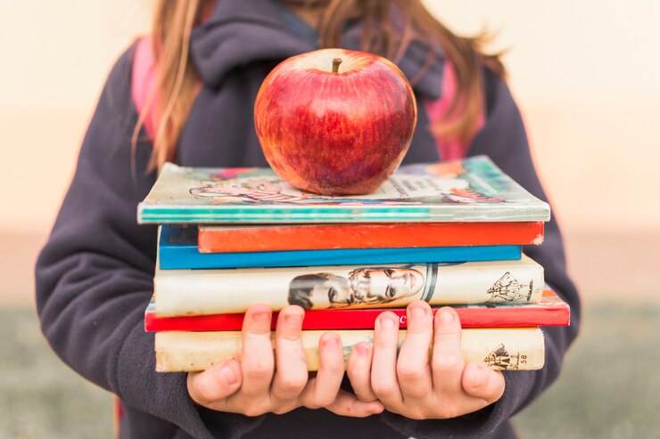 crop-girl-with-books-apple_23-2147863702