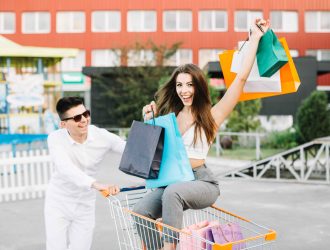 man-driving-shopping-cart-with-happy-woman (1)