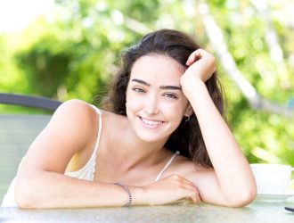 smiling-young-woman-sitting-outdoor-cafe_1262-5818 (1)