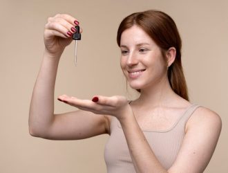 portrait-young-woman-pouring-serum-her-hand_23-2149259915