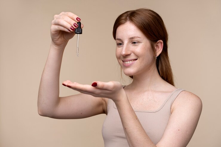 portrait-young-woman-pouring-serum-her-hand_23-2149259915