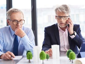 shocked-businessman-talking-by-mobile-phone-business-meeting_329181-19337