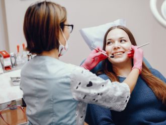 beautiful-girl-sitting-dentist-s-office_1157-19471