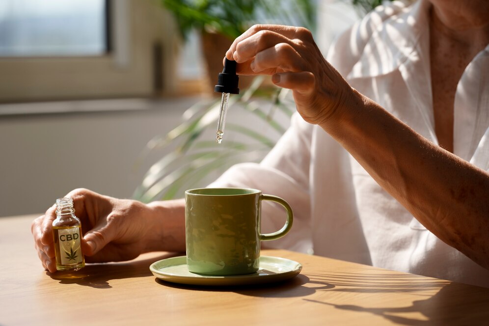 close-up-woman-putting-cbd-oil-drink_23-2150830186