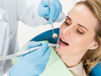 doctor-using-dental-drill-during-procedure-in-modern-dental-clinic