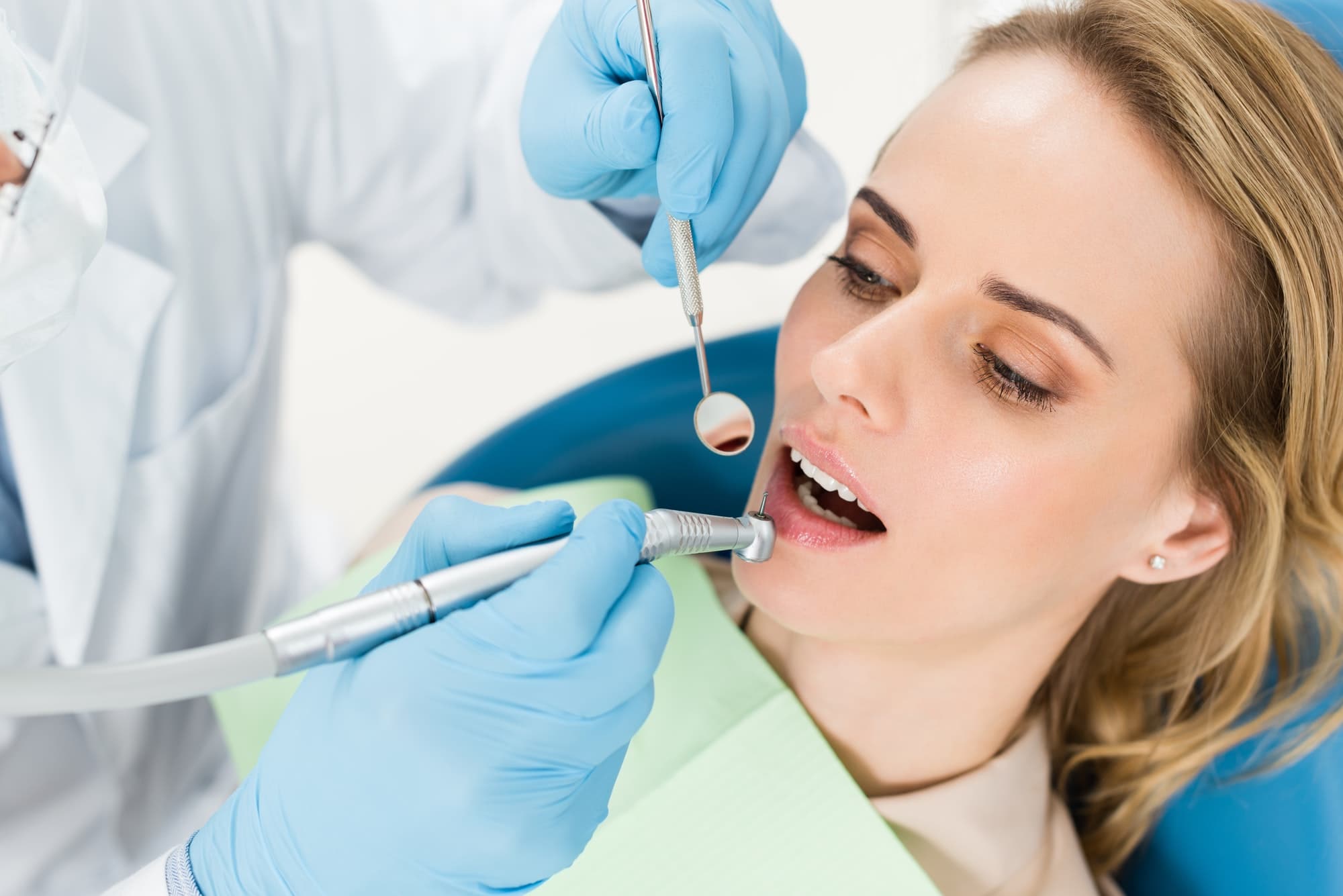 doctor-using-dental-drill-during-procedure-in-modern-dental-clinic