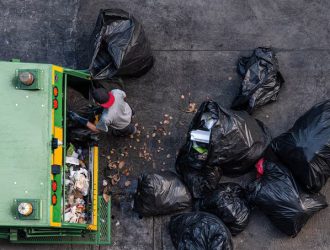 green-garbage-truck-employees-are-collecting-lot-black-garbage-bags_99266-549-ezgif.com-avif-to-jpg-converter