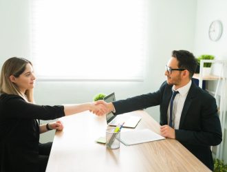 male-human-resources-manager-suit-shaking-hands-with-attractive-professional-woman-after-hiring-her-new-job (1)