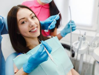 smiling-woman-dentist-chair_1153-655