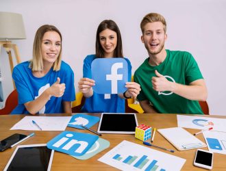 smiling-woman-holding-facebook-logo-with-his-friends-showing-thumbup-sign_11zon