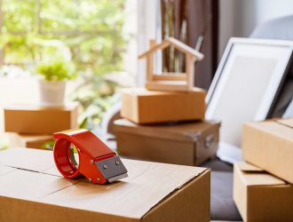 stack-of-cardboard-boxes-in-living-room-at-new-hou-2021-10-06-09-52-25-utc-scaled