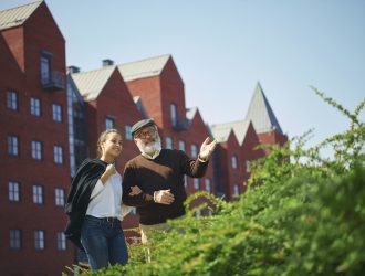 portrait-young-girl-embracing-grandfather-park-min